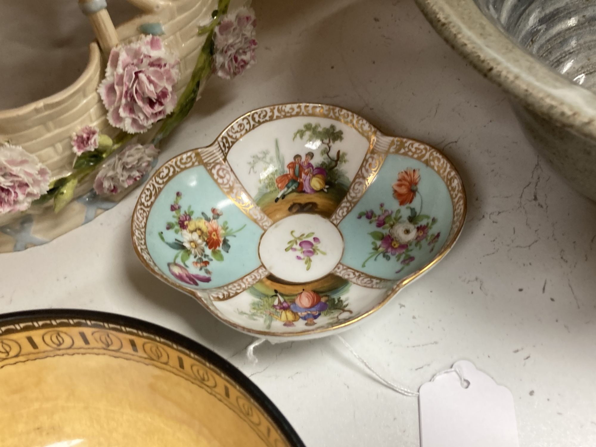 A Continental porcelain shaped oval posy basket encrusted with carnations and sundry ceramics,